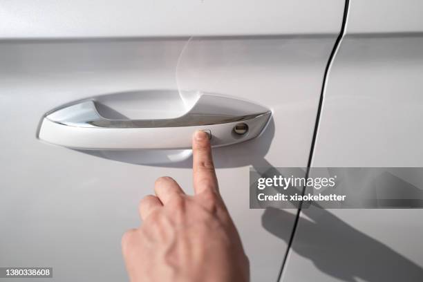 human hand touching door handle sensor of car - fühler stock-fotos und bilder