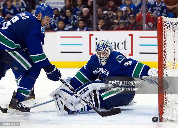 Goalie Cory Schneider and Sami Salo of the Vancouver Canucks watches a Chicago Blackhawks shot hit the post during the third period in NHL action on...