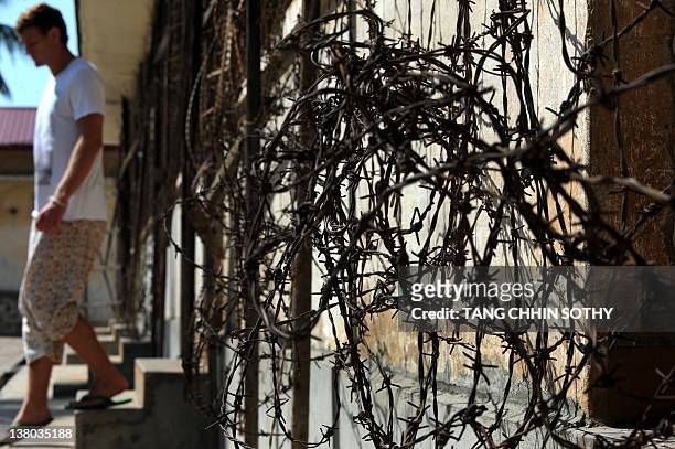Tourists walks through the Tuol Sleng genocide museum in Phnom Penh on February 1, 2012. A Khmer Rouge jailer who oversaw the deaths of 15,000 people...