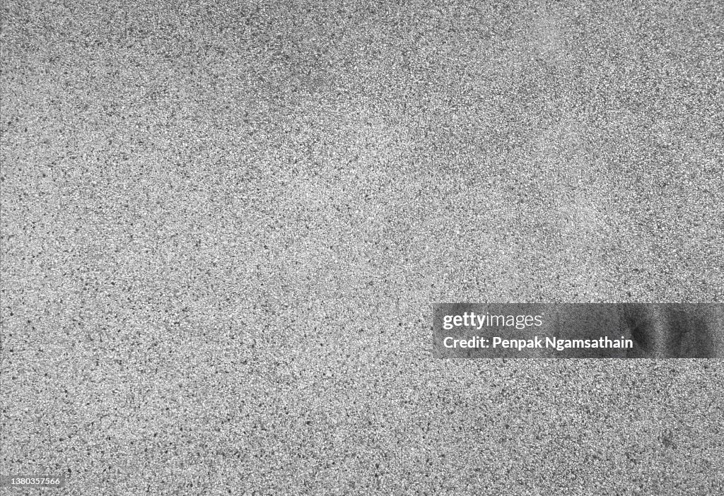Washed sand floor, black stone grains rough surface texture material background