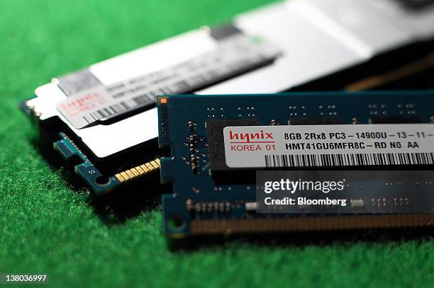 Hynix Semiconductor Inc. 8GB Double-Data-Rate 3 UDIMM memory chip, front, and 32GB LRDIMM memory chip are arranged for a photograph at the company's...