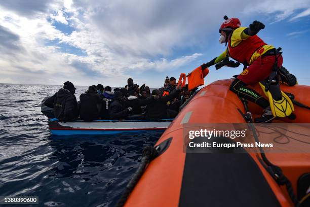 Members of the NGO Open Arms assist migrants who left the coast of Libya on Friday 4, in a wooden boat, March 5 off the coast of Libya, in the...