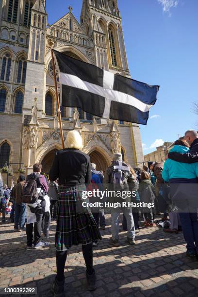 Cornishman in traditional costume flies the flag of St Piran during community singing on the steps of Truro Cathedral as the Cornish celebrate St...