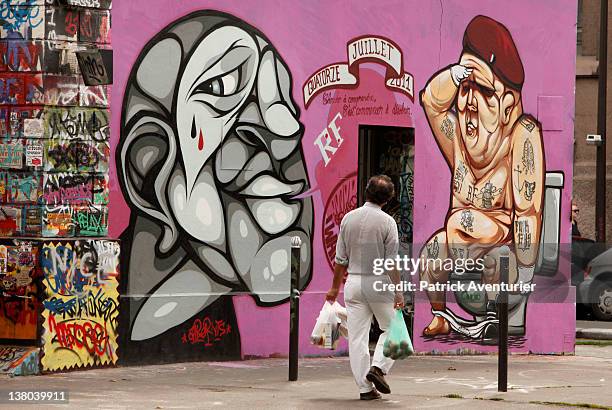 General view of graffiti street art covering the main wall of the old Central Bus station at Rue des Pyrenees on January 7, 2012 in Paris, France....