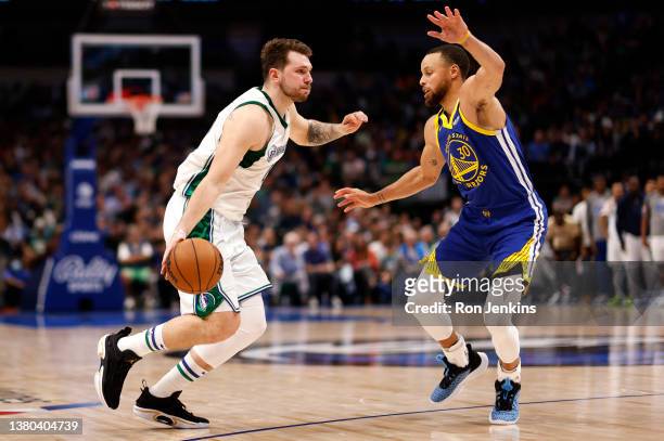 Luka Doncic of the Dallas Mavericks goes to the basket against Stephen Curry of the Golden State Warriors in the second half at American Airlines...