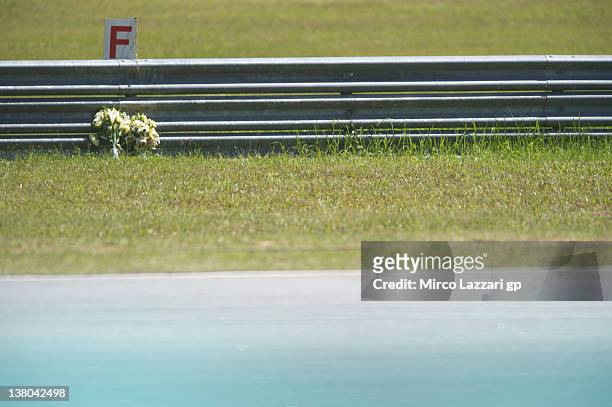 Bouquet of flowers in memory of Marco Simoncelli of Italy and San Carlo Honda Gresini is left by the side of the track during the second day of...