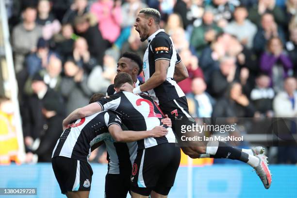 Ryan Fraser celebrates with teammates Joe Willock and Joelinton of Newcastle United after scoring their team's first goal during the Premier League...