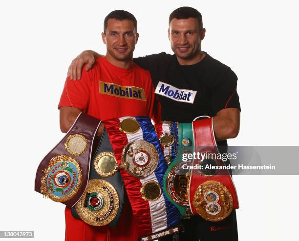 Wladimir Klitschko and his brother Vitali Klitschko pose with their championship belts including the WBO Super World Champion belt, "THE RING"...