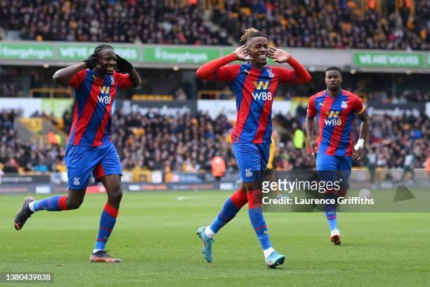 Wilfried Zaha of Crystal Palace celebrates with teammate Jean-Philippe Mateta after scoring their side's second goal from the penalty spot during the...
