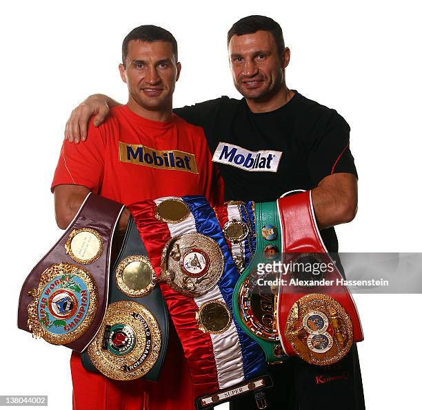 Wladimir Klitschko and his brother Vitali Klitschko pose with their championship belts including the WBO Super World Champion belt, "THE RING"...