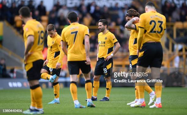Joao Moutinho of Wolverhampton Wanderers looks dejected with teammates after the Crystal Palace second goal scored by Wilfried Zaha from the penalty...