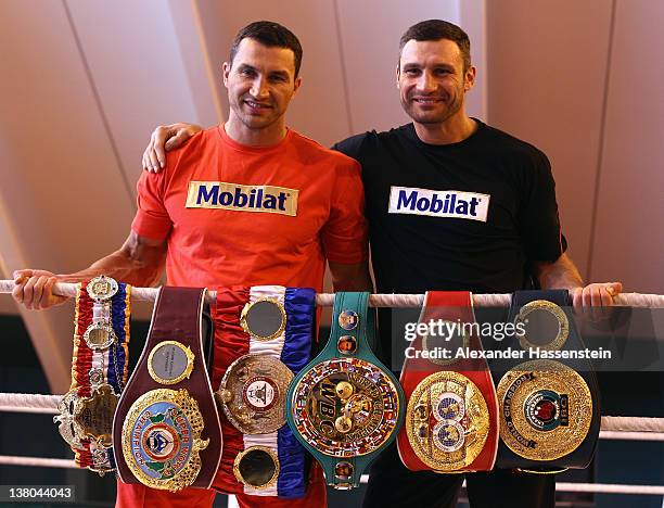 Wladimir Klitschko and his brother Vitali Klitschko pose with their championship belts including the "THE RING" magazine belt , WBO Super World...