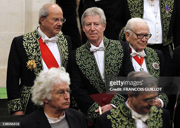 French film director and producer, Regis Wargnier talks with academicians Marc Ladreit de Lacharrière near Pierre Cardin during the Wargnier's...