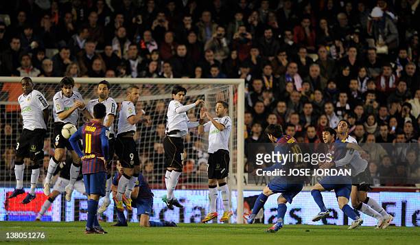 Barcelona's Argentinian forward Lionel Messi shoots against Valencia's defenders during the Spanish Cup semi-final match Valencia CF vs Barcelona on...