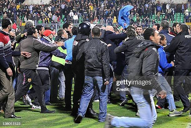 Egyptian football fans rush to the pit during riots that erupted after a football match between Al-Masry and Al-Ahly teams in Port Said, 220 kms...