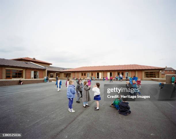 Whitecote Primary School, Wellington Grove, Bramley, Leeds, . Children playing games in the playground at Whitecote Primary School, Leeds, looking...