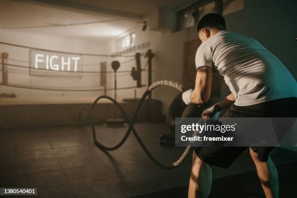 boxer training with battle ropes - boxing ropes stockfoto's en -beelden