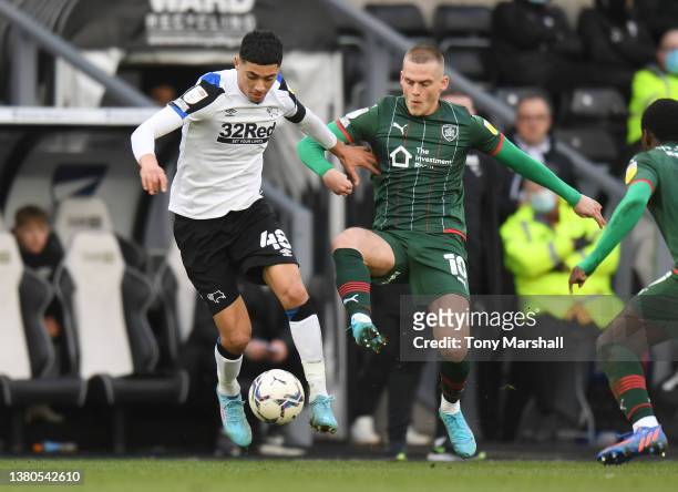 Luke Plange of Derby County is challenged by Josh Benson of Barnsley during the Sky Bet Championship match between Derby County and Barnsley at Pride...