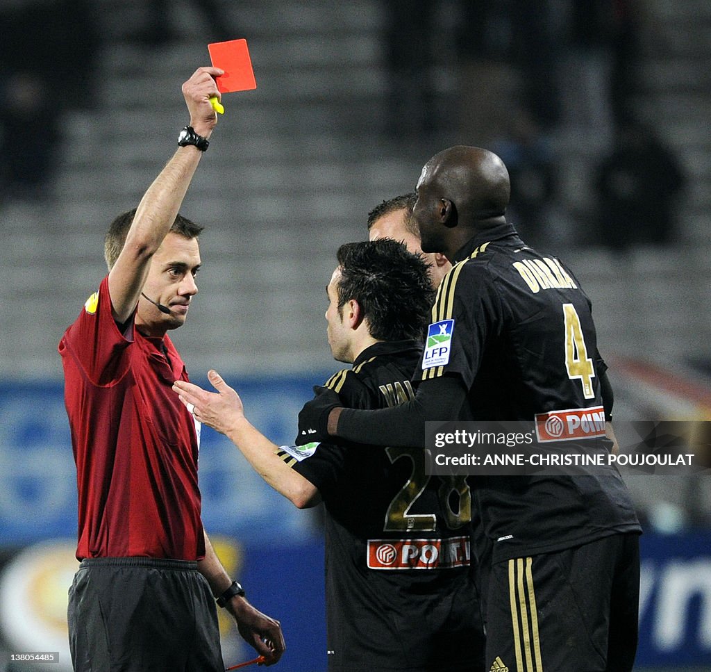 The referee (L) delivers a red card to M