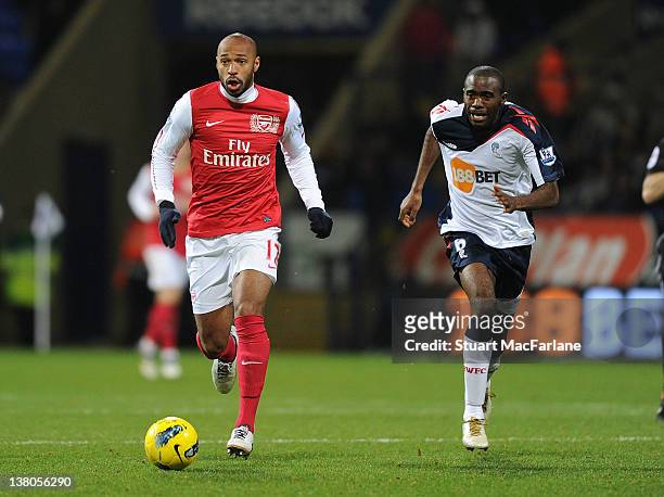 Thierry Henry of Arsenal breaks past Fabrice Muamba of Bolton during the Barclays Premier League match between Bolton Wanderers and Arsenal at the...