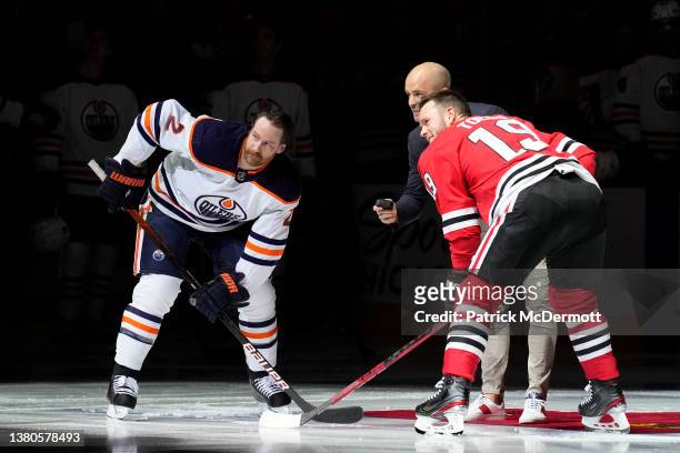 Former Chicago Blackhawks player Niklas Hjalmarsson drops the puck with Duncan Keith of the Edmonton Oilers and Jonathan Toews of the Chicago...