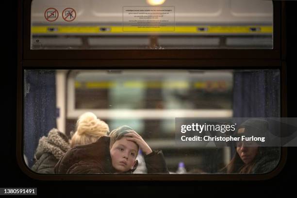 Boy refugees looks out of the window as he arrives at Zahony train station as the influx of refugees from Ukraine continues on March 05, 2022 in...