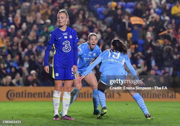 Caroline Weir of Manchester City celebrates with teammate Alanna Kennedy after scoring their team's third goal as Sophie Ingle of Chelsea looks...