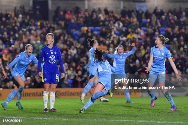 Caroline Weir of Manchester City celebrates with teammates after scoring their team's third goal as Sophie Ingle of Chelsea looks dejected during the...