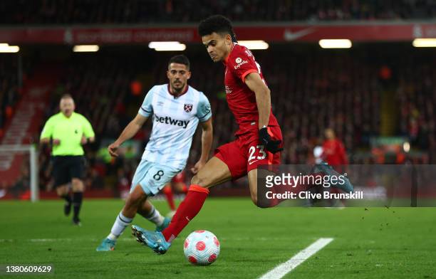 Luis Diaz of Liverpool runs with the ball from Pablo Fornals of West Ham United during the Premier League match between Liverpool and West Ham United...