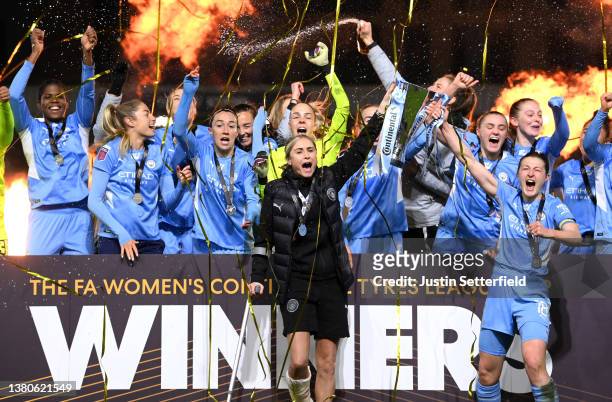 Steph Houghton and Ellen White of Manchester City lift the FA Women's Continental Tyres League cup trophy following their side's victory in the FA...