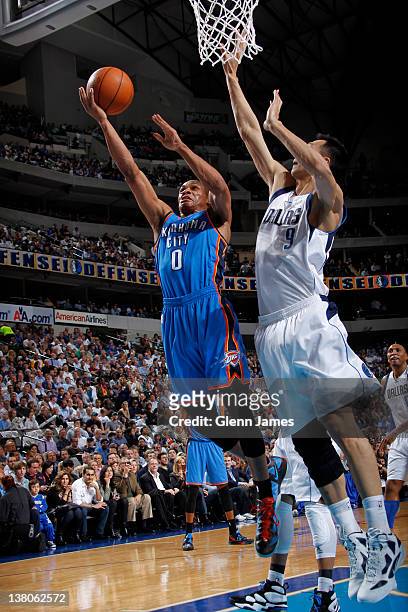 Russell Westbrook of the Oklahoma City Thunder goes in for the layup against Yi Jianlian of the Dallas Mavericks on February 1, 2012 at the American...