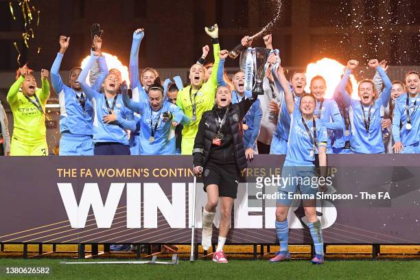 Ellen White of Manchester City lifts The FA Women's Continental Tyres League Cup trophy together with Steph Houghton of Manchester City following...
