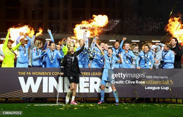 Steph Houghton and Ellen White of Manchester City lift the FA Women's Continental Tyres League cup trophy following their side's victory in the FA...