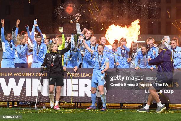 Ellen White of Manchester City lifts The FA Women's Continental Tyres League Cup trophy together with Steph Houghton of Manchester City following...