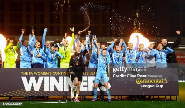 Steph Houghton and Ellen White of Manchester City lift the FA Women's Continental Tyres League cup trophy following their side's victory in the FA...