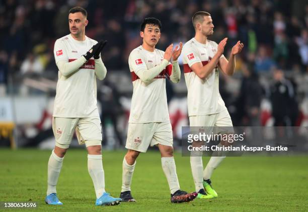 Philipp Forster, Wataru Endo and Sasa Kalajdzic of Stuttgart acknowledge the fans after the match during the Bundesliga match between VfB Stuttgart...
