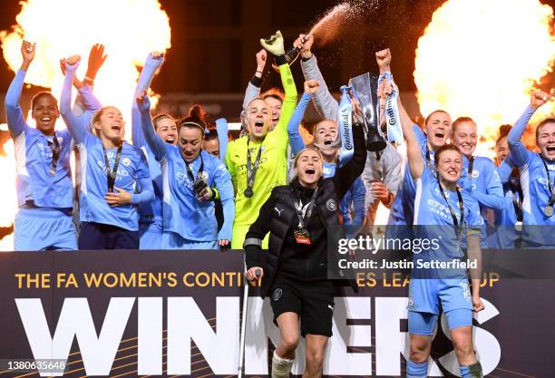 Steph Houghton and Ellen White of Manchester City lift the FA Women's Continental Tyres League cup trophy following their side's victory in the FA...