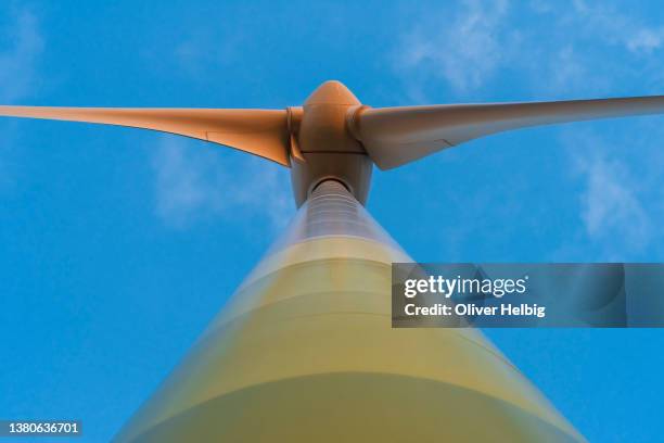 low angle view  close up wind turbine against cloudy sky - climate solutions stock pictures, royalty-free photos & images