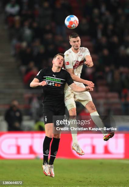 Philipp Forster challenges in the air with Luca Netz of Borussia Monchengladbach during the Bundesliga match between VfB Stuttgart and Borussia...