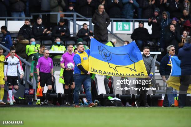 Derby County and Ukraine fans lead out the teams before of the Sky Bet Championship match between Derby County and Barnsley at Pride Park Stadium on...