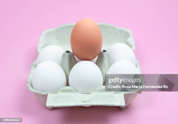 from view of carton containers with white and brown raw chicken eggs on pin background. - brown box stock pictures, royalty-free photos & images