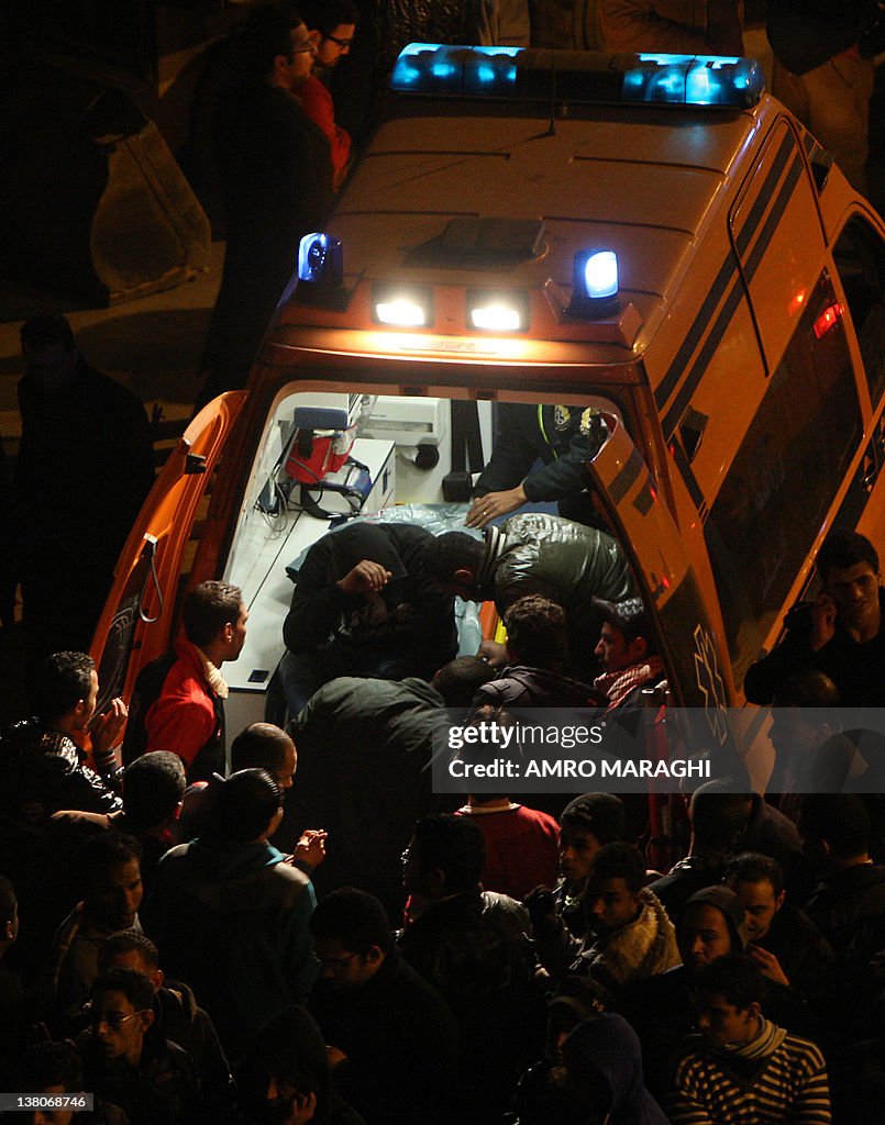 Egyptians gather around an ambulance out