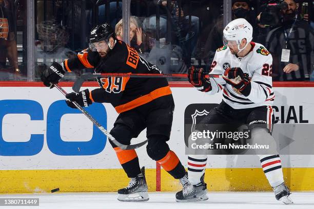 Derick Brassard of the Philadelphia Flyers and Ryan Carpenter of the Chicago Blackhawks challenge for the puck during the first period at Wells Fargo...