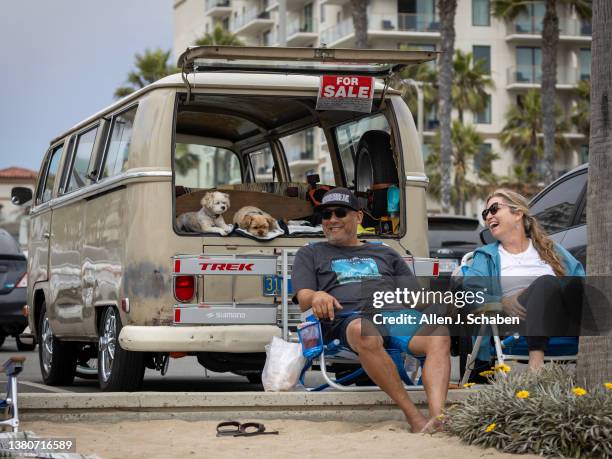 Huntington Beach, CA Mike and Amber Perez, of Tustin and dogs Ziggy, left, and Taz, shown relaxing in their 1970 VW bus, relax beachside and escape...