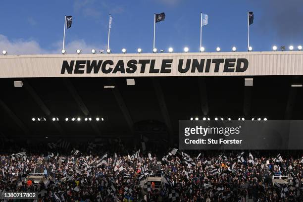 Newcastle fans waving flags during the Premier League match between Newcastle United and Brighton & Hove Albion at St. James Park on March 05, 2022...