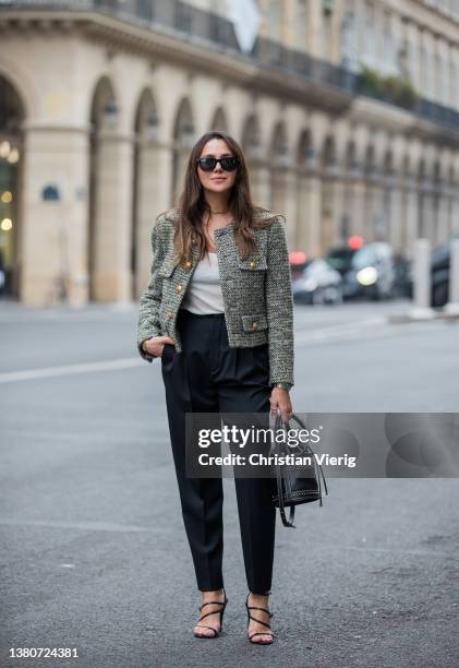 Yasemin Ögün seen wearing YSL black bucket bag, Chanel tweed jacket, black high waist pants, white shirt, Audemars Piguet watch, heeled sandals on...