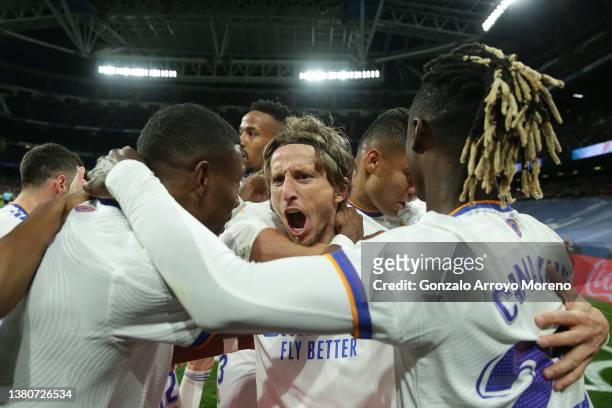 Luka Modric of Real Madrid CF celebrates scoring their second goal with teammates during the LaLiga Santander match between Real Madrid CF and Real...