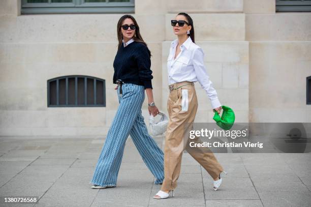 Yasemin Ögün seen wearing blue white striped pants, brown belt, navy v neck knit, white button shirt, white Bottega Veneta pants, heels, Audemars...