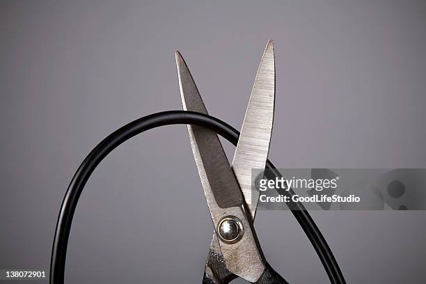 close up of metal scissors cutting black wire - cutting stock pictures, royalty-free photos & images