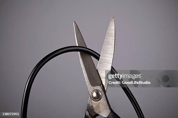 close up of metal scissors cutting black wire - cable bildbanksfoton och bilder